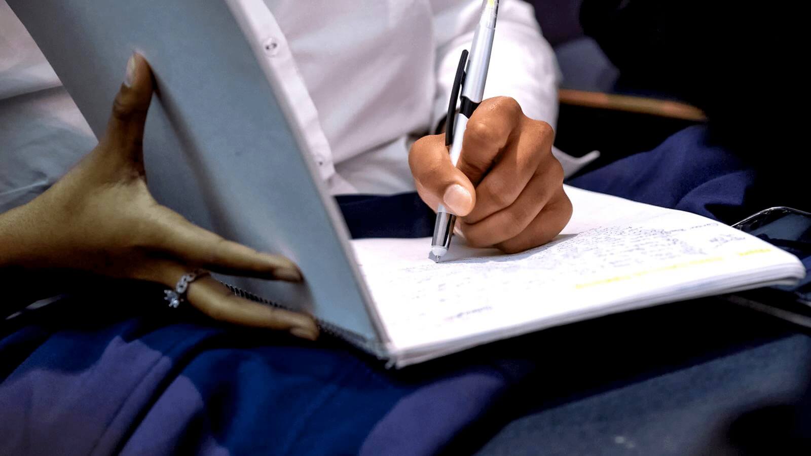 Student writing in notebook