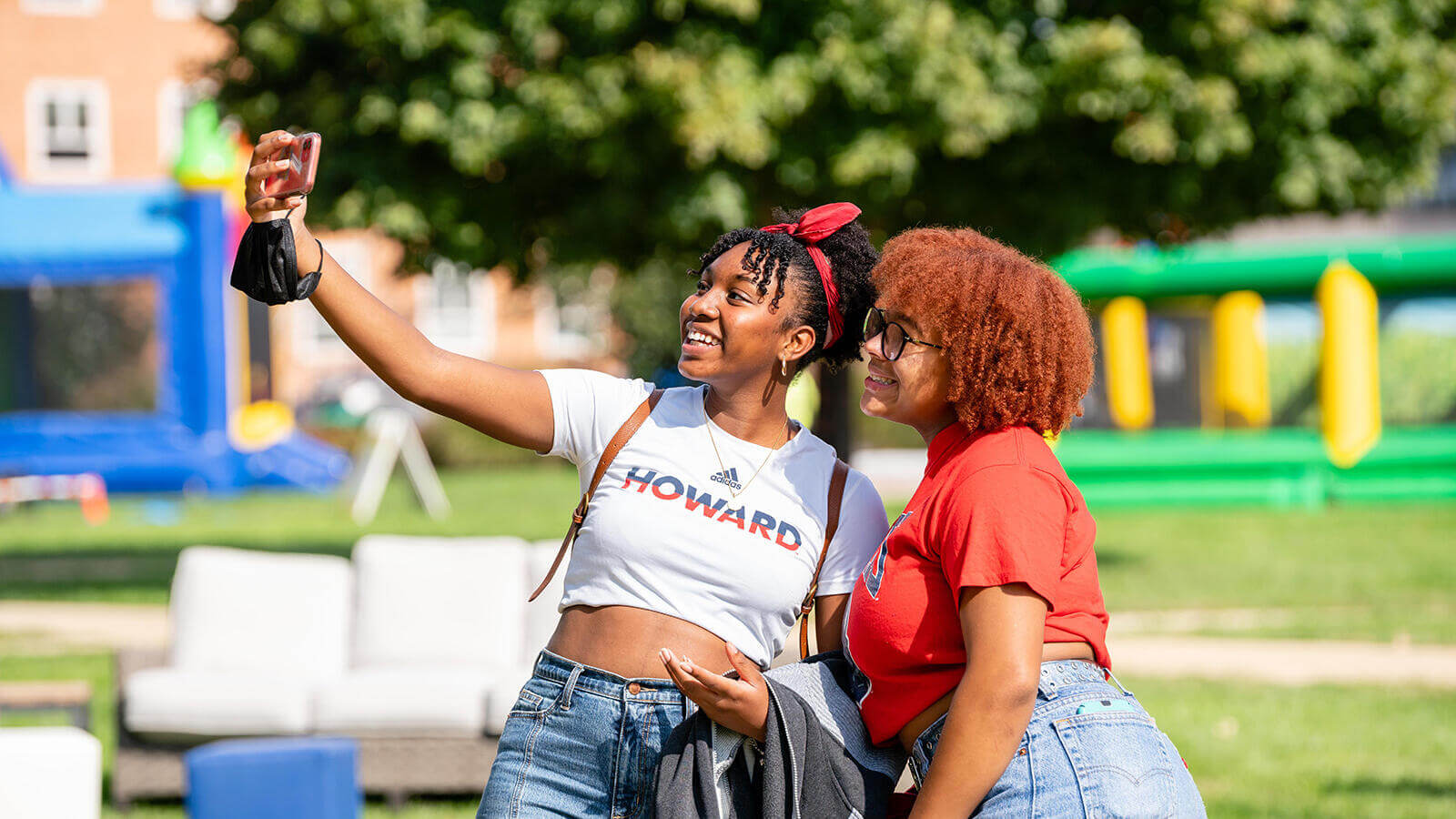 Friends smiling and taking a photo outside