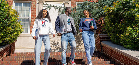 Howard students smiling and walking down stairs
