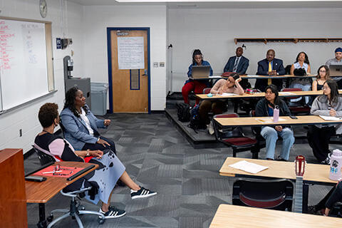 Professor and students in a classroom discussing a lesson